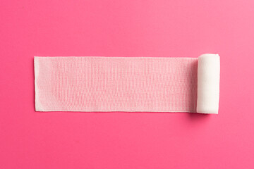 First aid, injury protecting wrapping and wound dressing concept clean cotton gauze bandage isolated on colorful background with space for sign.