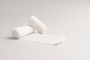 White medical cotton gauze bandage on colorful, Medical bandage of new first aid gauze unrolling