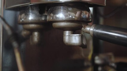 Coffee making in a coffee machine at the coffee shop, coffeehouse. Once tempered, holder is inserted into the coffee group and includes strait. Espresso dripping into white cup. Stages making coffee. - Powered by Adobe