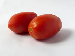 Two ripe tomatoes on a white background