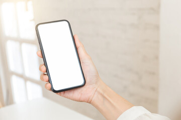 cell phone blank white screen mockup.hand holding texting using mobile on desk at office.background empty space for advertise.work people contact marketing business,technology