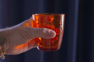 hand holding an empty glass