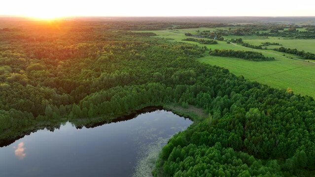 Lake in the forest at sunset. Freshwater Lakes. Water supply problems and water deficit, ecology and environmental. Lake on sunrise in rural, aerial view. Freshwater Lakes. Drink water safe. 