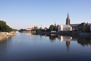 Odra river and tree on Ostrow Tumski in the morning fog. Sunrise over river. Wroclaw.