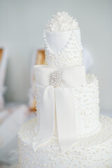 white wedding cake with ribbon