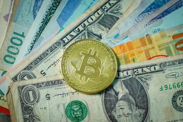 Bitcoin cryptocurrency on banknote background.