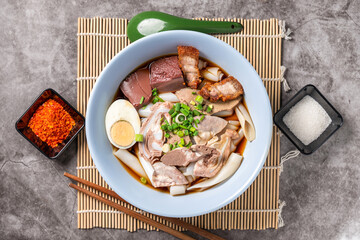 Paste of rice flour Chinese Roll Noodle Soup ( Kuay Jab
) with Crispy pork and Seasoning.