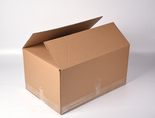 brown cardboard box sealed with adhesive tape on a white background