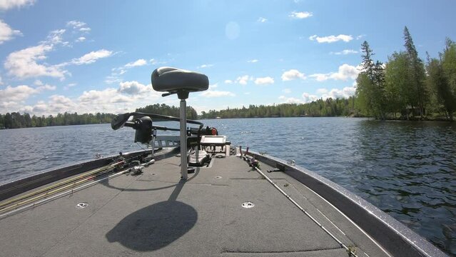 Front deck of bass fishing boat while floating on a Lake Vermilion on summer day in northern Minnesota; concepts of fishing, peaceful, and vacation