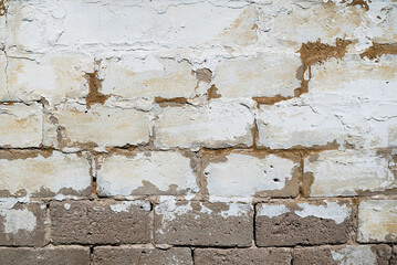 Very old wall with partially chipped plaster.
