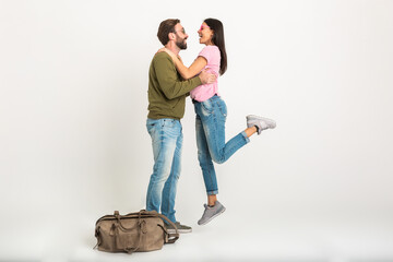 couple smiling woman and man in sweatshirt with travel bag