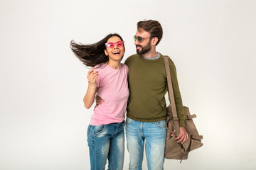 couple smiling woman and man in sweatshirt with travel bag