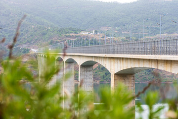 Fototapeta premium A high bridge over the dam in the countryside.