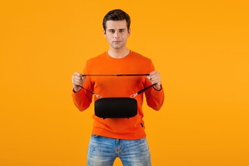 stylish young man holding wireless speaker