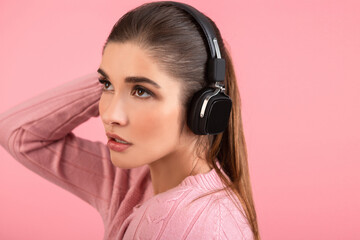 young woman listening to music in headphones