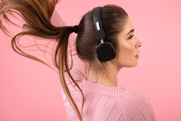 young woman listening to music in headphones