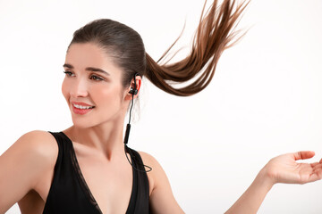 Fototapeta premium attractive woman in jogging black top listening to music on earphones