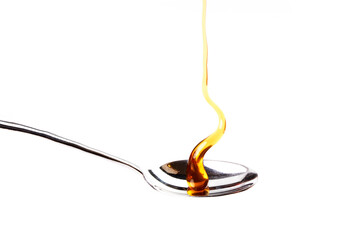 Delicious honey dripping on a teaspoon. Healthy food
