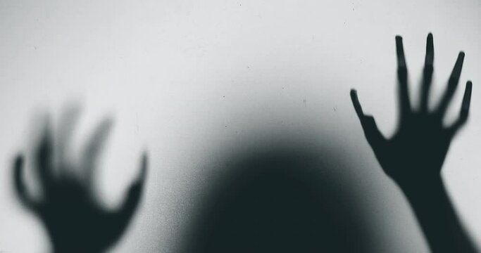 Shadow of a zombie hand on white background
