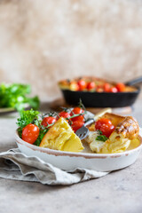 Savory Dutch baby pancake with roasted cherry tomatoes, mozzarella cheese and green salad leaves. Danish cuisine. Hearty breakfast recipes.