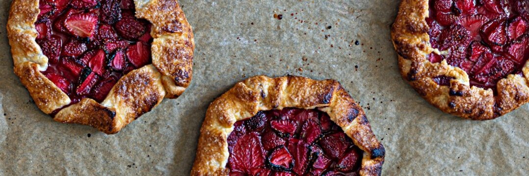 French dessert Galette with shortbread and strawberries. Open pie with berries. Banner.
