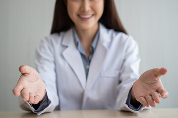 Asian doctor is online visiting with a patient on the internet application and make a note of the...