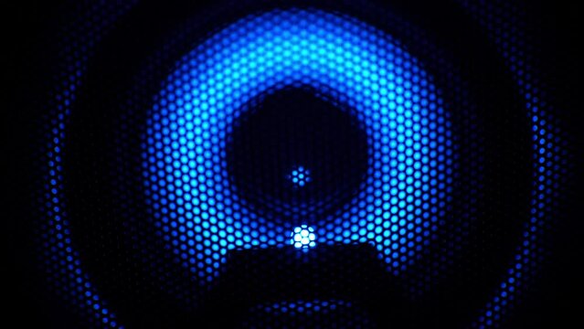 Speaker with blue neon light flashing, music festival concept