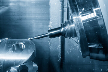 The multi-tasking CNC machine milling the automotive transmission part.