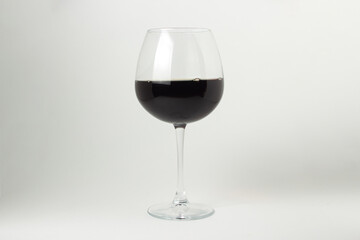 A glass of red wine on a white background. Alcoholic drink.