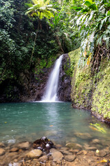 Seven Sisters Waterfalls in Grenada Grand Etang National Park. One of Grenada's most beautiful areas where a waterfall rushes down the mountainside into a large pool perfect for swimming. Slow shutter - obrazy, fototapety, plakaty