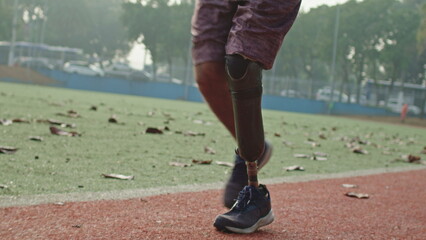 Disabled Athlete running with prosthetic leg at running track. Motivational amputee athlete runner - obrazy, fototapety, plakaty