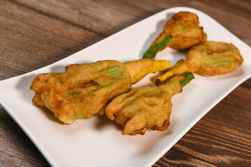 Stuffed zucchini flower on plate. High quality photo