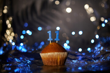 Digital gift card birthday concept. Tasty fresh homemade vanilla cupcake with number 11 eleven on...
