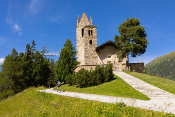 Fototapeta na wymiar cycling tour near the ancient church of Celerina in Engadine, Switzerland
