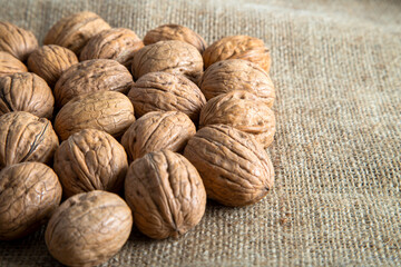 Whole shell walnuts on burlap sack,top view