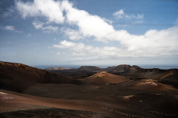 View of a volcano craters in Timanfaya National Park, a protected volcanic area located  in the south west coast of Lanzarote, Canary Islands, Spain.