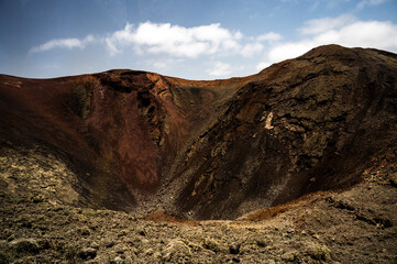 View of a volcano crater in Timanfaya National Park, a protected volcanic area located  in the south west coast of Lanzarote, Canary Islands, Spain.