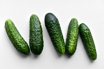 Green fresh cucumbers on a white background