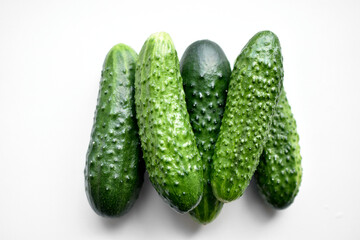 Green fresh cucumbers on a white background
