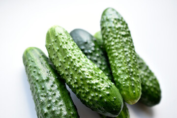 Green fresh cucumbers on a white background