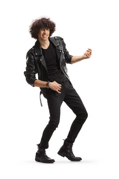 Cheerful young man in a leather jacket pretending to play a guitar