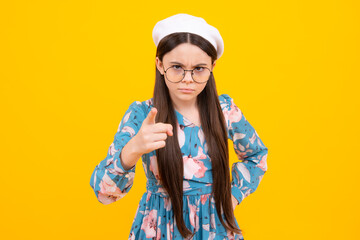 Serious teenager girl. Teen girl pointing finger at camera, point index finger camera on you.