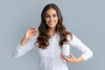 Woman with bottle pills. Happy young African American woman holding bottle of dietary supplements or vitamins in her hands. Healthy lifestyle concept.