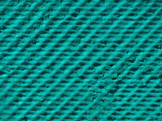 Textured turquoise background. Relief surface of bright green color- background texture
