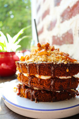 chocolate biscuit cake with caramel on a wooden table in a cafe