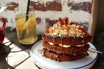 chocolate biscuit cake with caramel on a wooden table in a cafe
