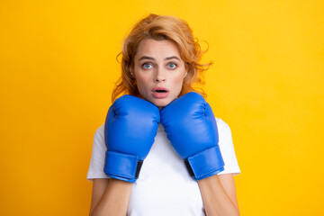 Woman in boxing gloves. Surprised female boxer.