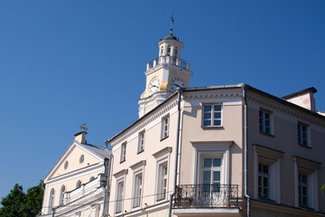 Fototapeta na wymiar Old Town Hall in Vitebsk, Belarus. City Hall, Clock Tower Is Famous Landmark In Sunny Day On Blue Sky Background