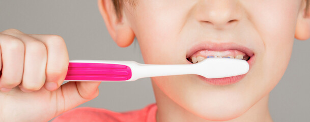 Boy toothbrush white toothpaste. Health care, dental hygiene. Joyful child shows toothbrushes. Little boy cleaning teeth. Dental hygiene. Happy little kid brushing her teeth