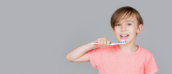Dental hygiene. Happy little kid brushing her teeth. Kid boy brushing teeth. Boy toothbrush white toothpaste. Health care, dental hygiene